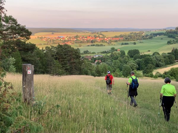 Abendlicher Abstieg vom Hahnberg nach Hümpfershausen am Hozizont die Gleichberge bei Römhild